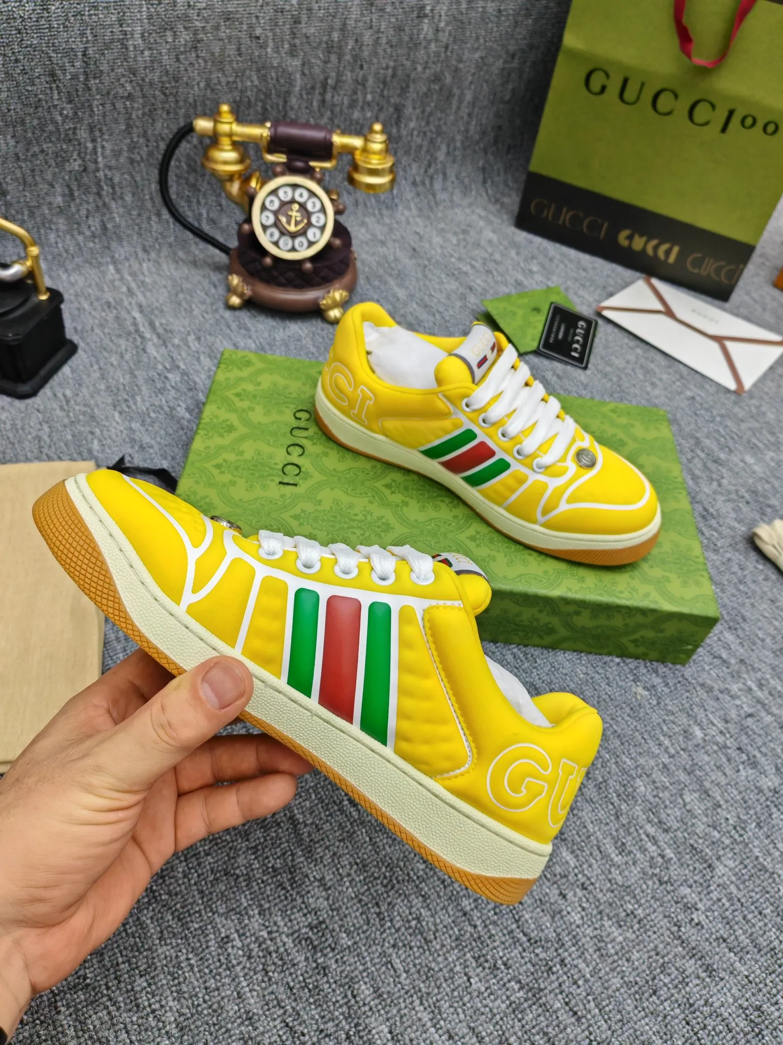 Factory price 600💰Screener series embellished web sneakers. This item is from the Gucci Lido series. Its design is inspired by the summer style and beach clubs of the Italian coast. The Screener series of sneakers draws inspiration from classic sneakers from the 1970s and takes its name from a special defensive move in sports. This shoe from the 2024 Pre-Fall collection is crafted from yellow rubber, a technical and malleable opaque material, with striped webbing on the sides and an embossed Gucci printed logo on the heel. Yellow rubber, opaque and technological in appearance. Red and green webbing decorated with metal Double G oval enamel details. Gucci printed embossed logo. Women 35-40, men 38-45, (men 38 and 45 need to be customized)